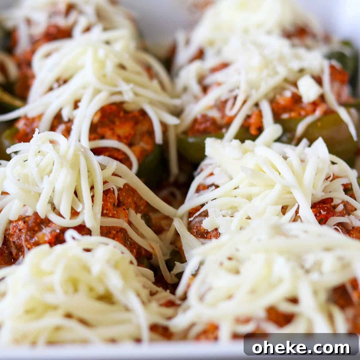 stuffed peppers topped with mozzrella cheese ready for baking