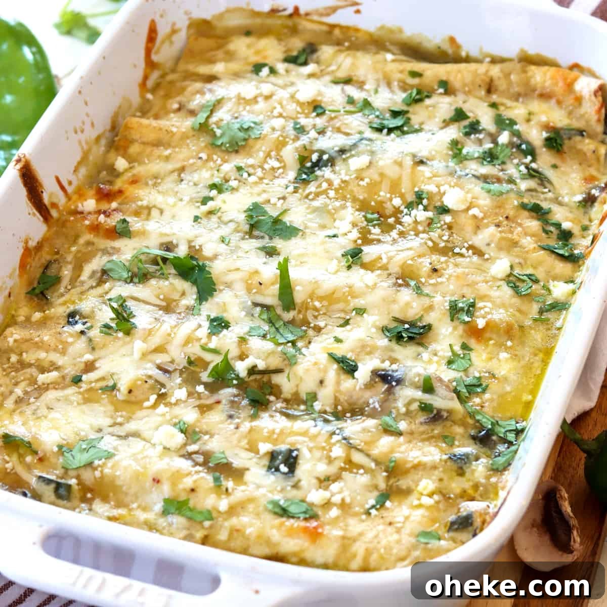 Baked seafood enchiladas in a white rectangle casserole dish.