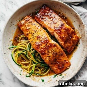 Maple-Glazed One-Pan Salmon Recipe for Quick Weeknight Meals 6 Maple glazed salmon in a pan with zucchini noodles.