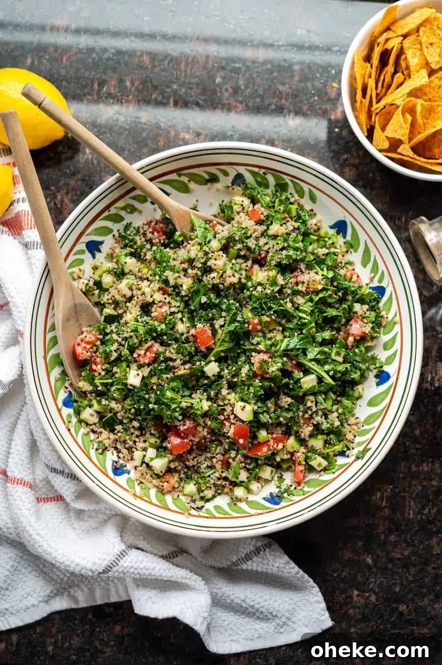 Kale and Quinoa Tabbouleh Salad with Lemon Herb Dressing 7 Image of kale quinoa tabbouleh salad in a large ceramic bowl, on granite countertop.
