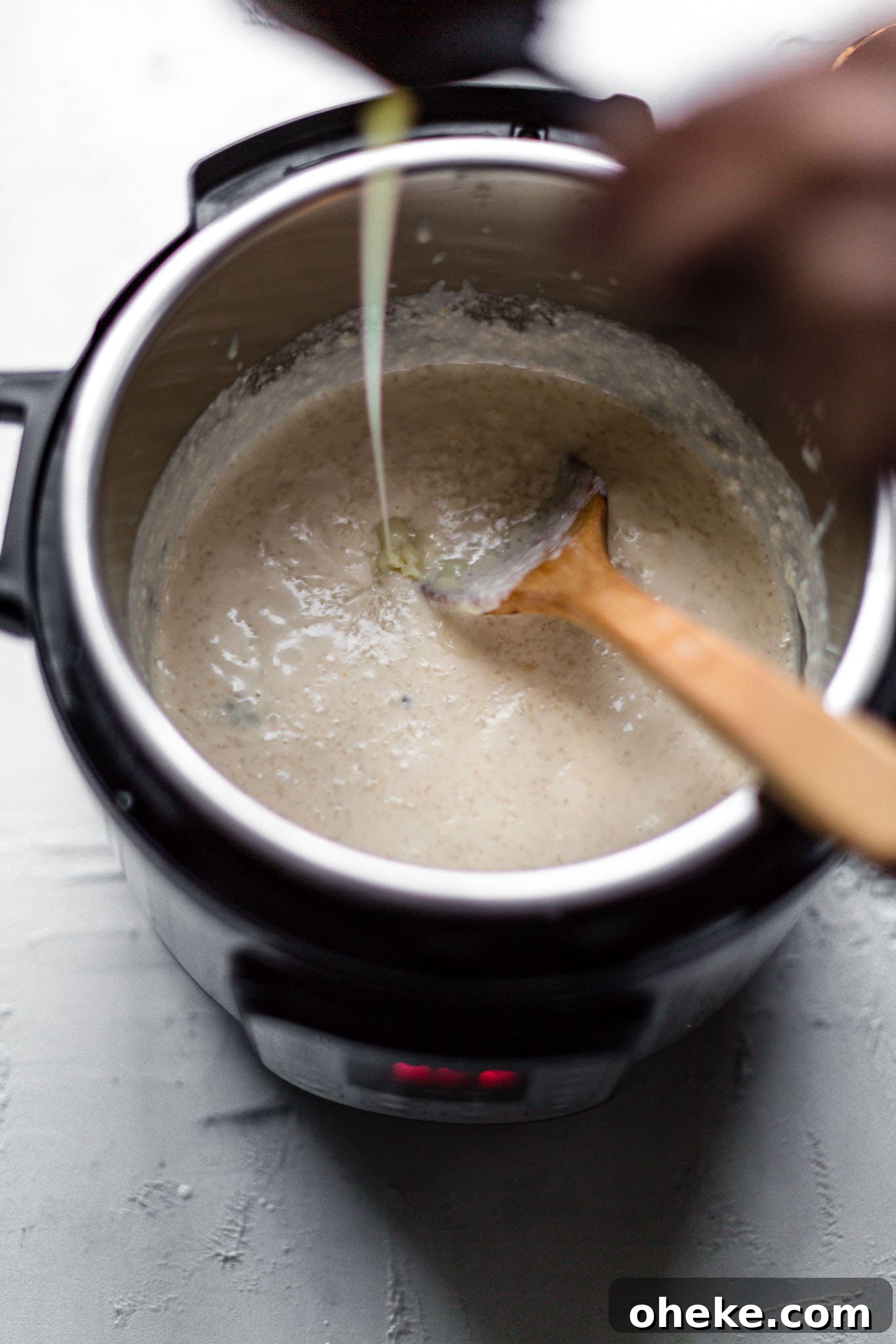 Creamy Instant Pot Kheer Recipe – Quick & Authentic Guide 8 Pouring condensed milk into kheer in the Instant Pot