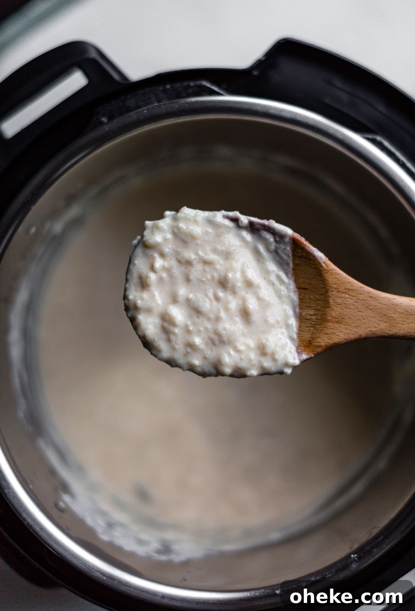 Creamy Instant Pot Kheer Recipe – Quick & Authentic Guide 9 Showing texture of Instant Pot kheer on a wooden spoon