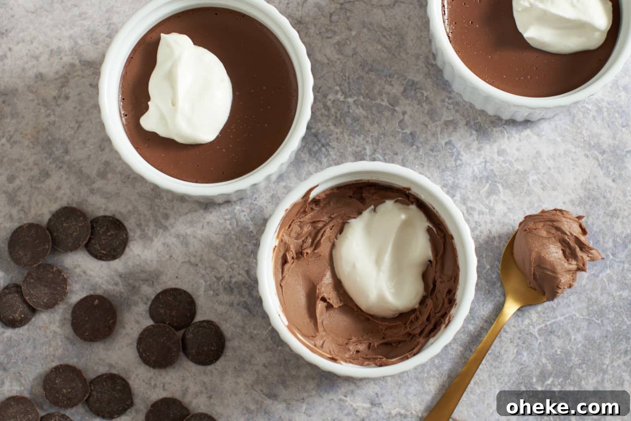 Chocolate Pots de Crème: Simple Stove-Top Method for Rich Dessert 2 Three chocolate pots de creme with whipped cream on top. Chocolate wafers are on the left, a spoon with chocolate on it is on the right.