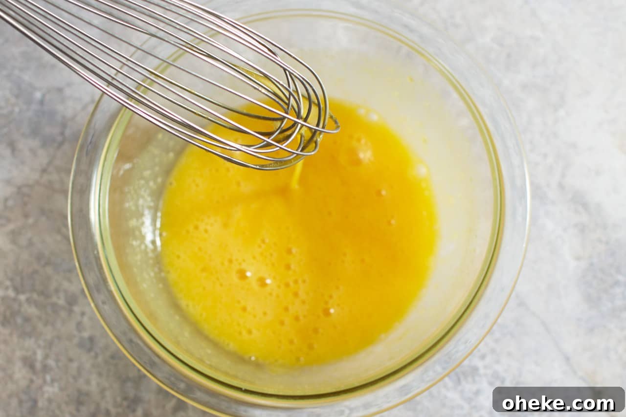 Chocolate Pots de Crème: Simple Stove-Top Method for Rich Dessert 6 A whisk in a bowl of eggs mixed with sugar.