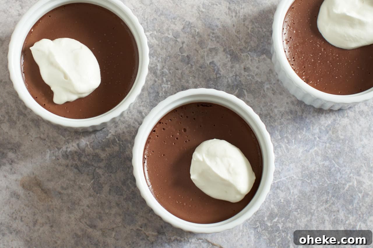 Chocolate Pots de Crème: Simple Stove-Top Method for Rich Dessert 8 Three chocolate pots de creme topped with whipped cream.