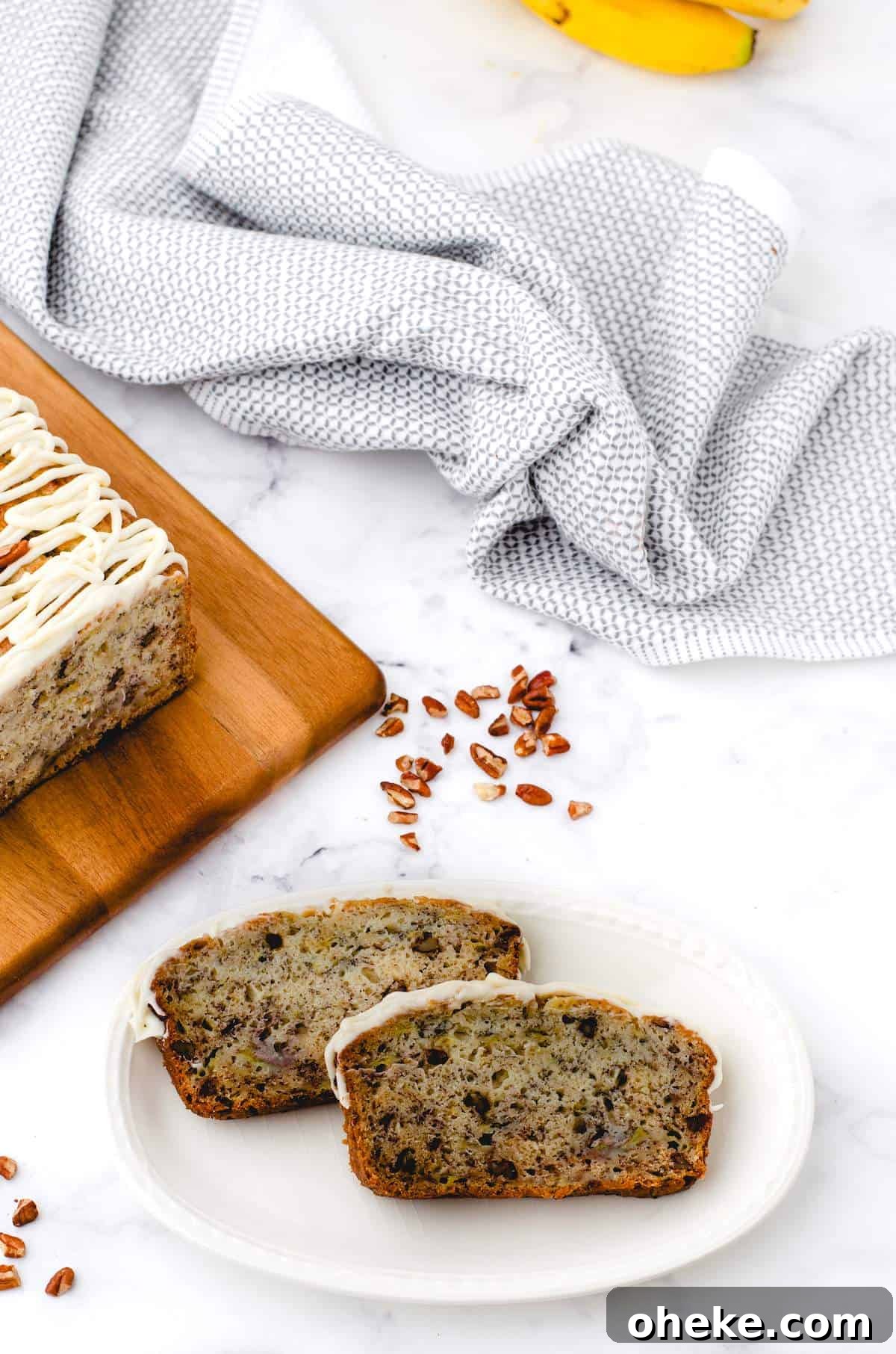 Moist Buttermilk Banana Bread Recipe with Brown Butter Glaze 9 Slices of buttermilk banana bread on a plate.