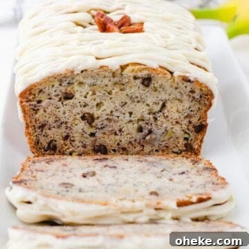 Moist Buttermilk Banana Bread Recipe with Brown Butter Glaze 10 A cross section of a loaf of buttermilk banana bread with cream cheese frosting drizzled on the top.