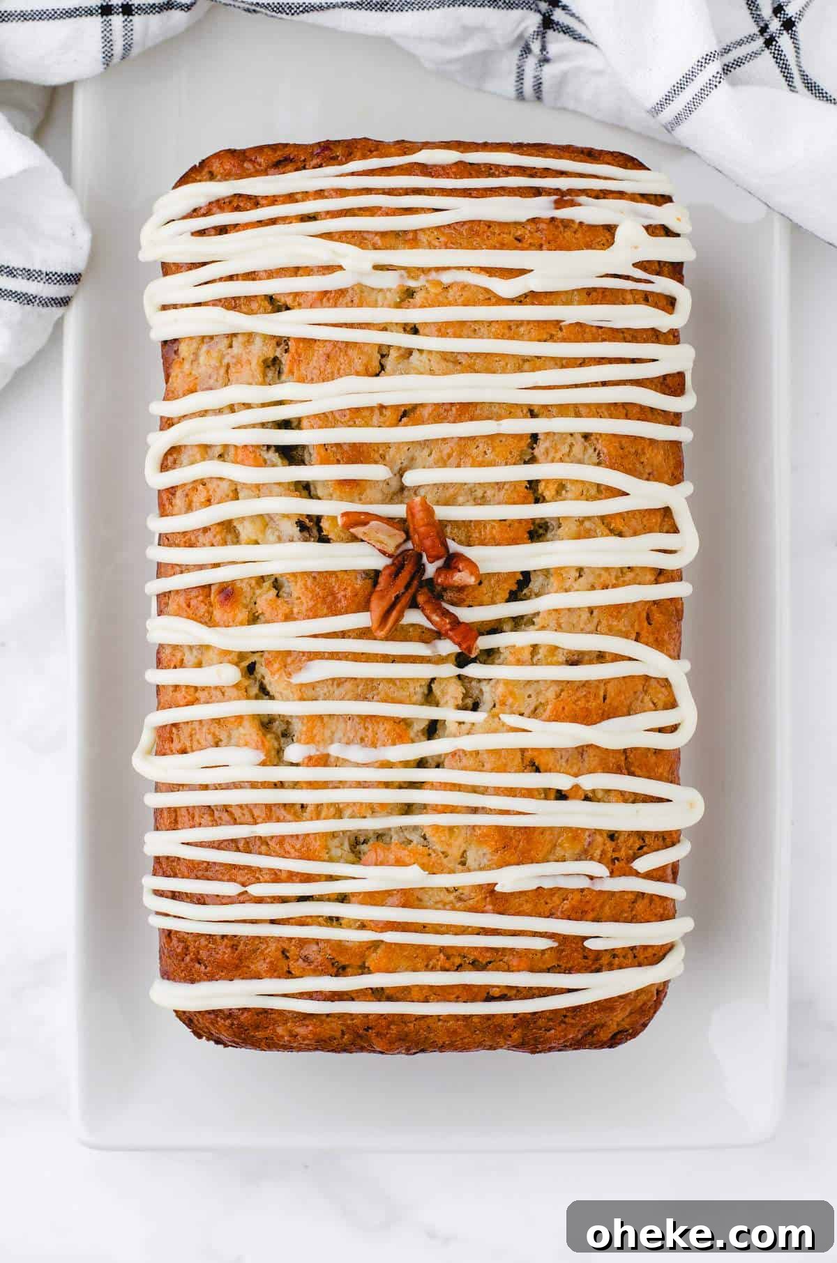 Moist Buttermilk Banana Bread Recipe with Brown Butter Glaze 7 A loaf of buttermilk banana bread with Cream Cheese Frosting drizzled over the top.