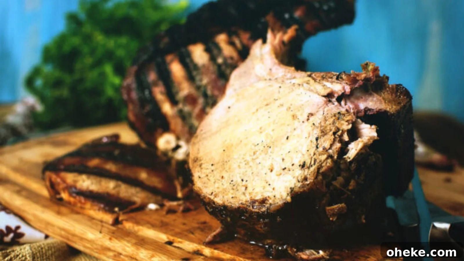 Char-grilled pork roast with seared edges sliced on a platter.