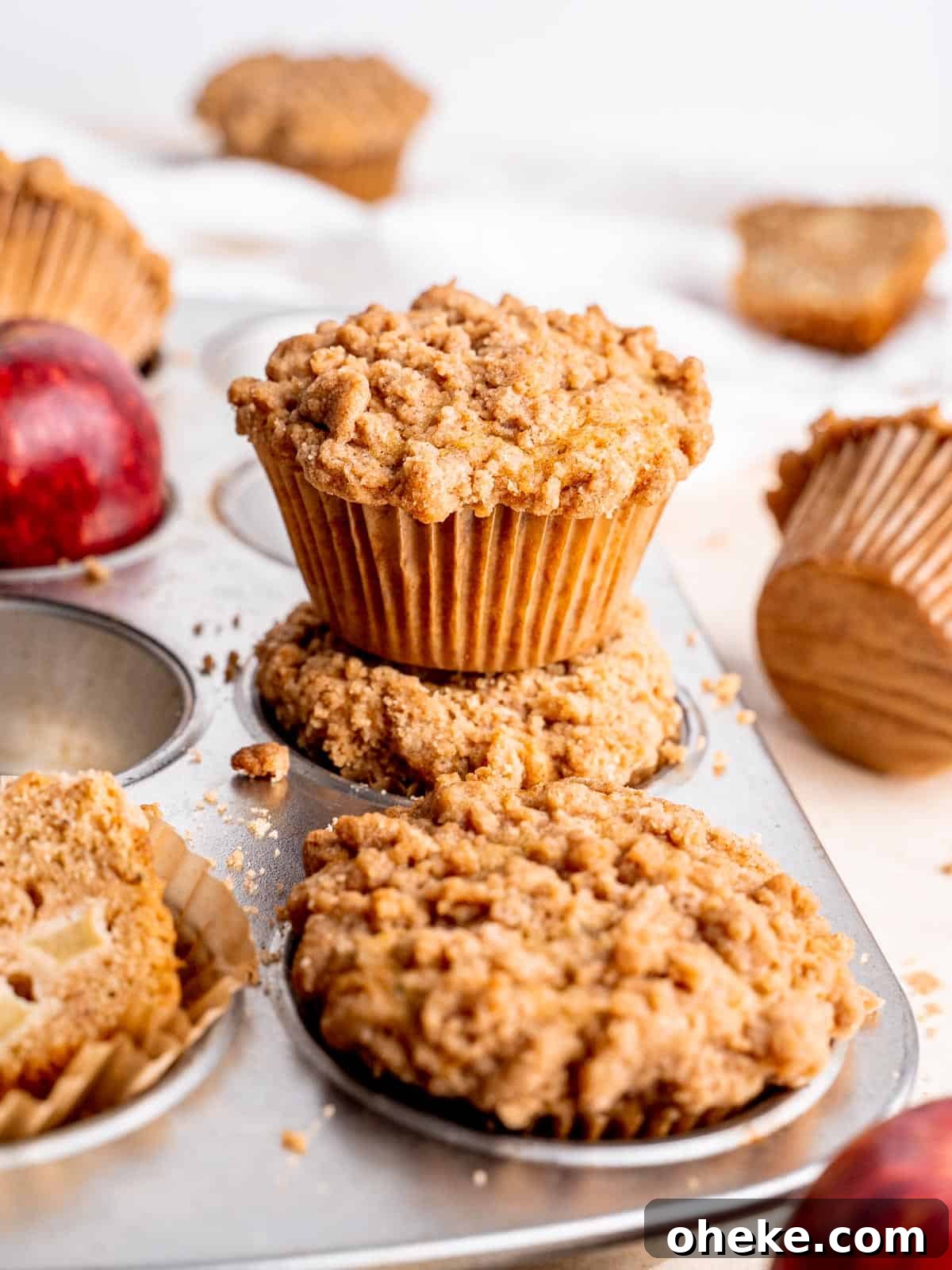 apple streusel muffins in a muffin tin