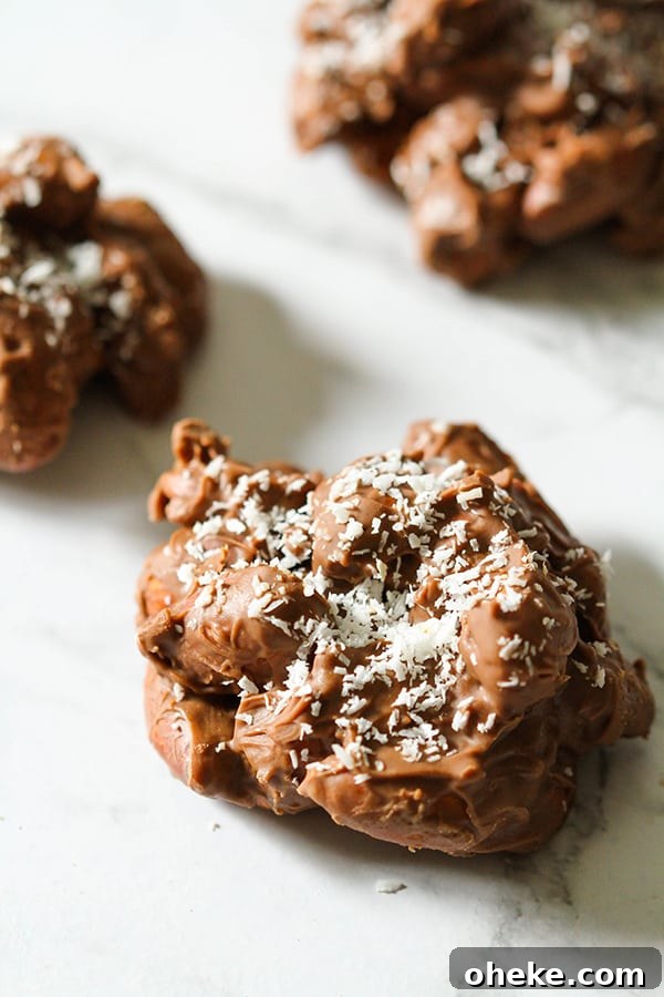 Crunchy Chocolate-Covered Almonds Recipe for Homemade Snacks 2 chocolate covered almonds on a marble background.