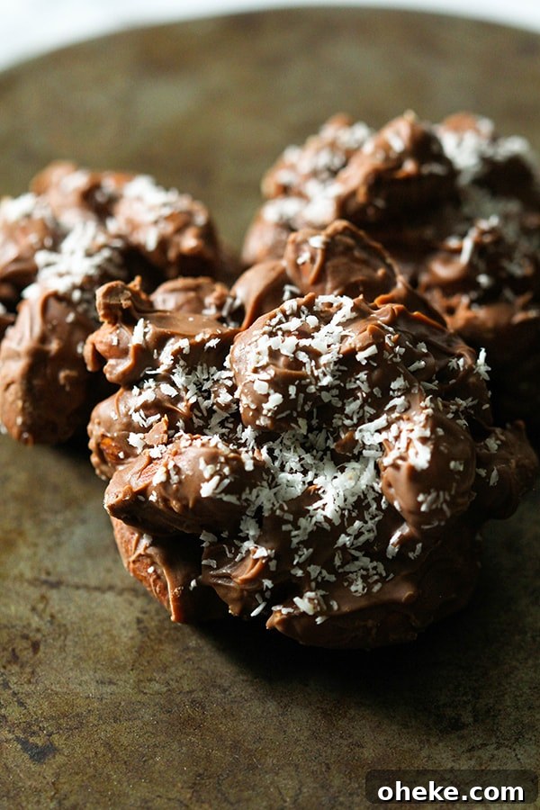 Crunchy Chocolate-Covered Almonds Recipe for Homemade Snacks 3 chocolate covered almonds on a rusted baking dish.