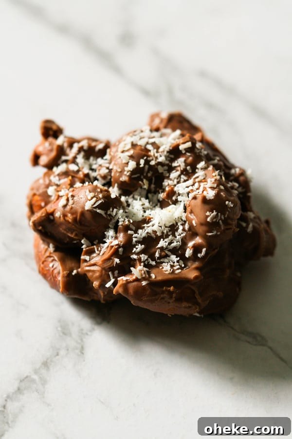Crunchy Chocolate-Covered Almonds Recipe for Homemade Snacks 10 a chocolate covered almond cluster on a marble background