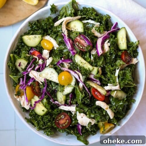 mediterranean kale salad in white bowl on white background