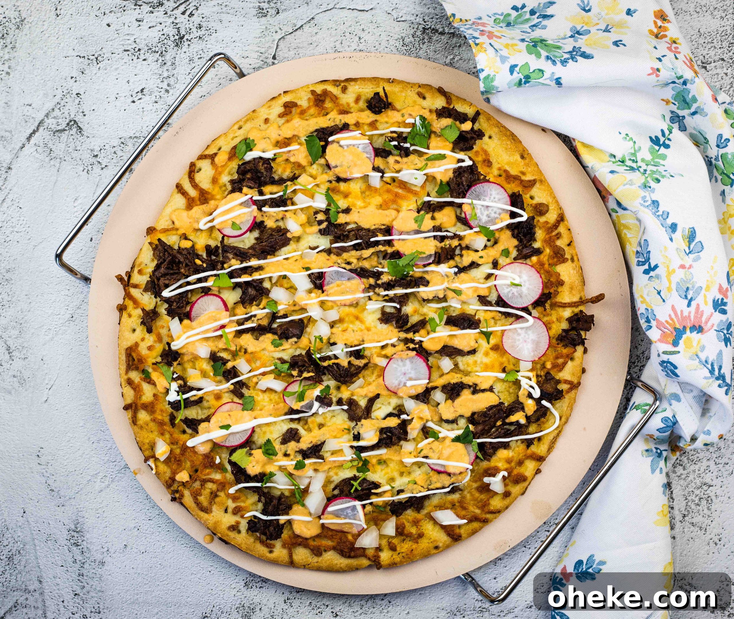 Birria Pizza on a pizza stone.