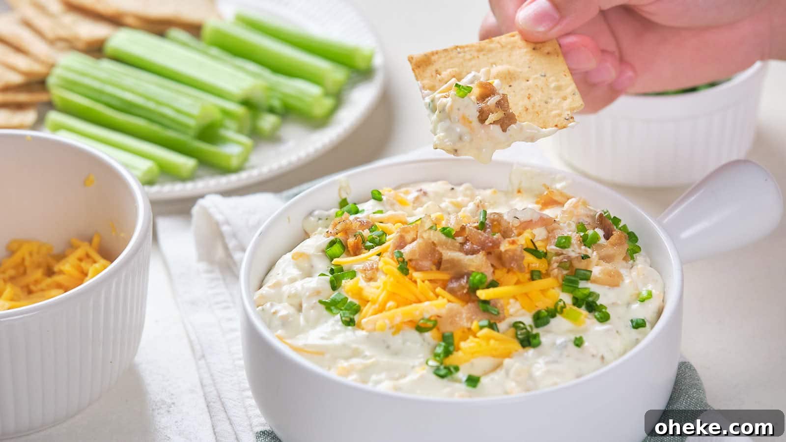 17 Comforting Recipes to Keep You Warm This Season 7 Bacon cheddar dip with shredded cheddar cheese, bacon bits, and chive garnish.