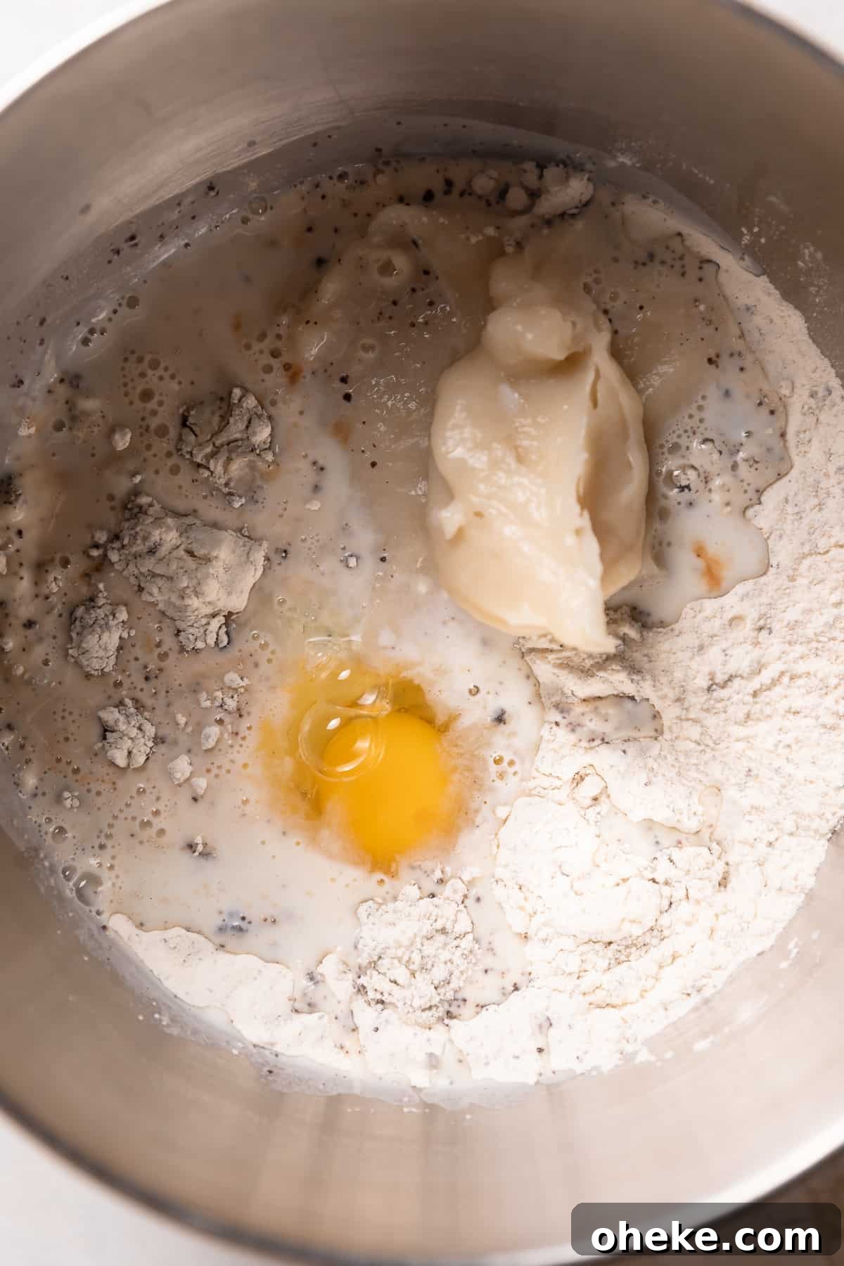 Cookies and Cream Cinnamon Rolls Recipe for Dessert Lovers 4 Wet ingredients for the cinnamon rolls being mixed into the dries.