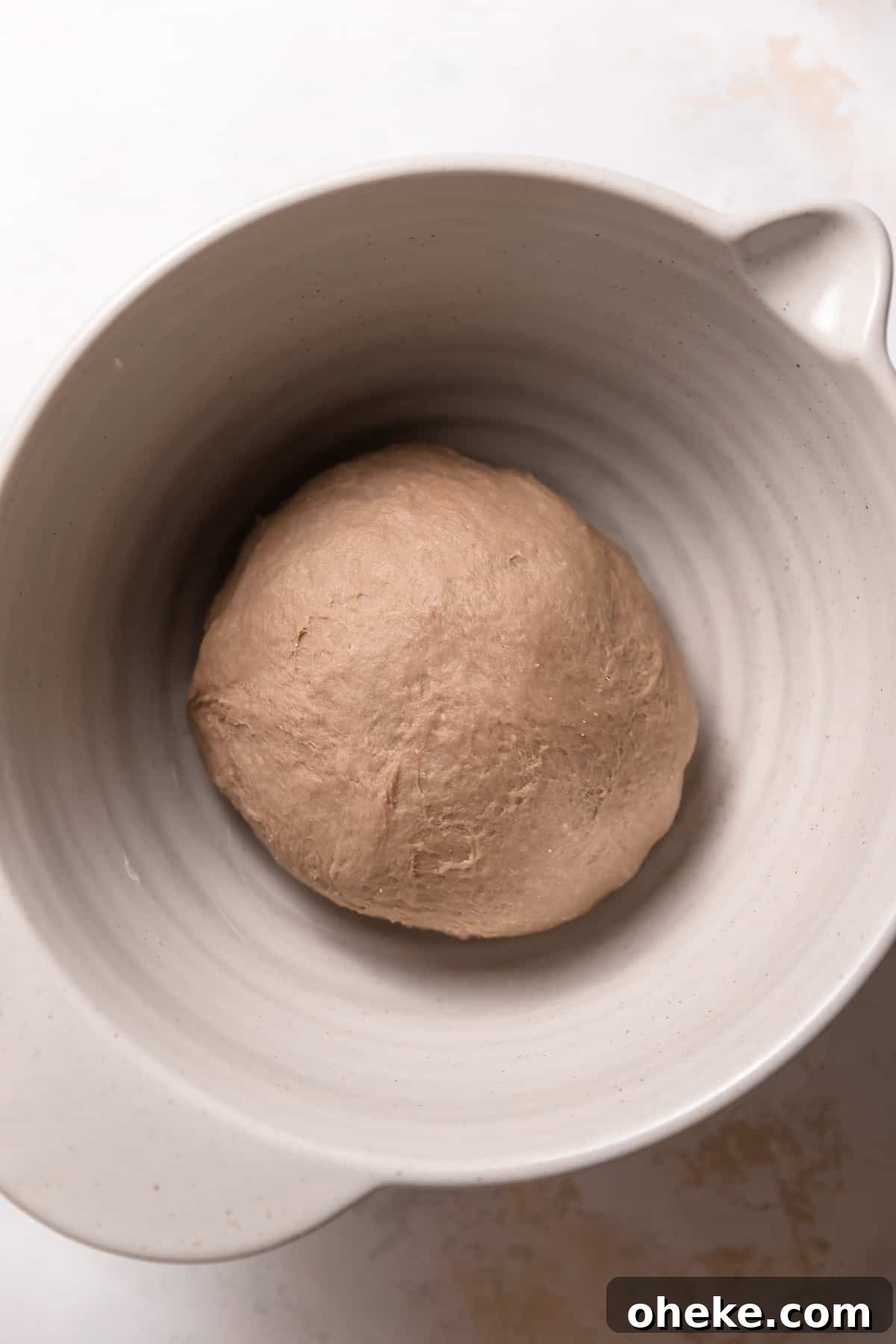 Cookies and Cream Cinnamon Rolls Recipe for Dessert Lovers 6 Round dough ball in a mixing bowl.