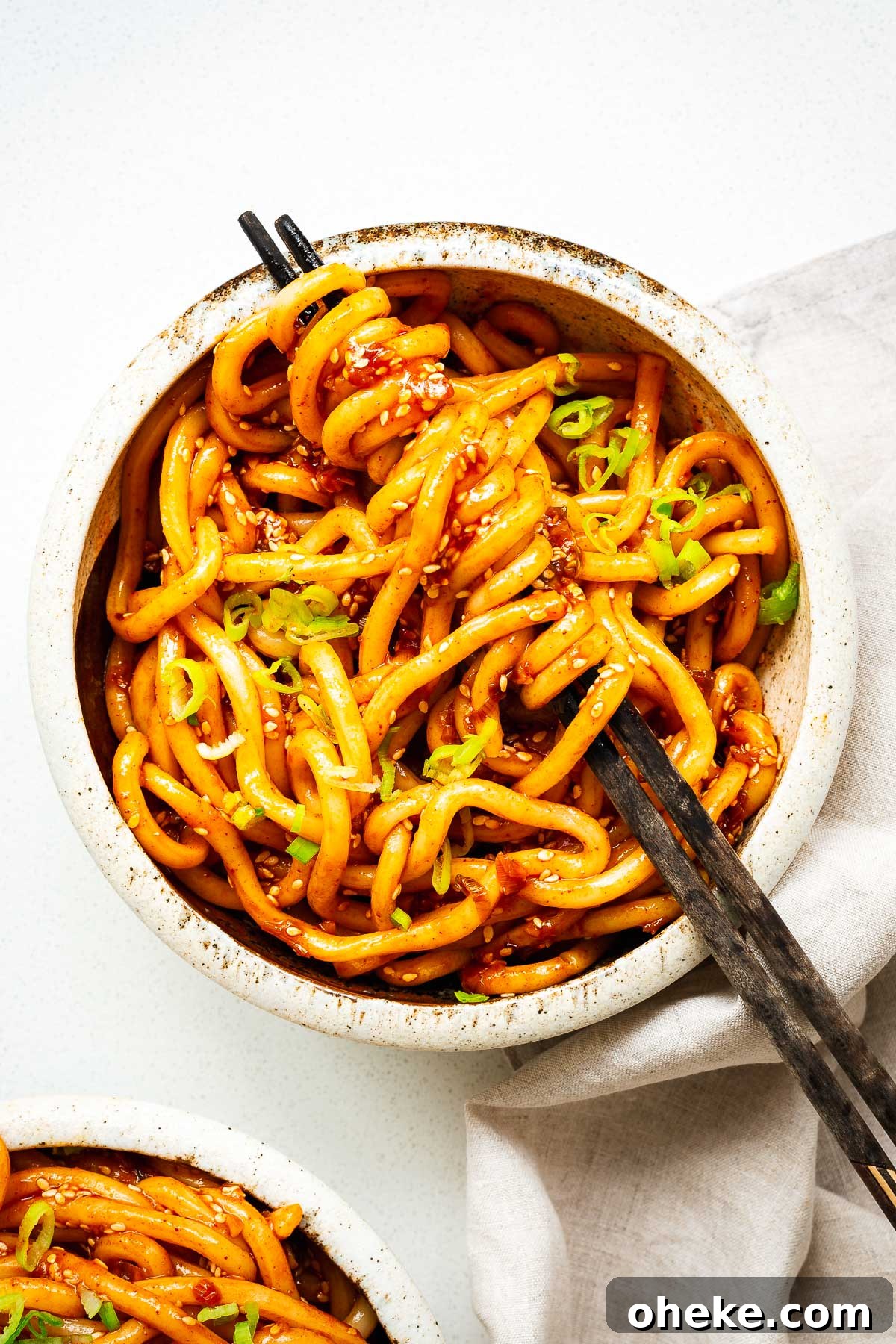 Spicy Gochujang Korean Noodles Recipe 2 A bowl of udon noodles with a spicy gochujang noodle sauce.
