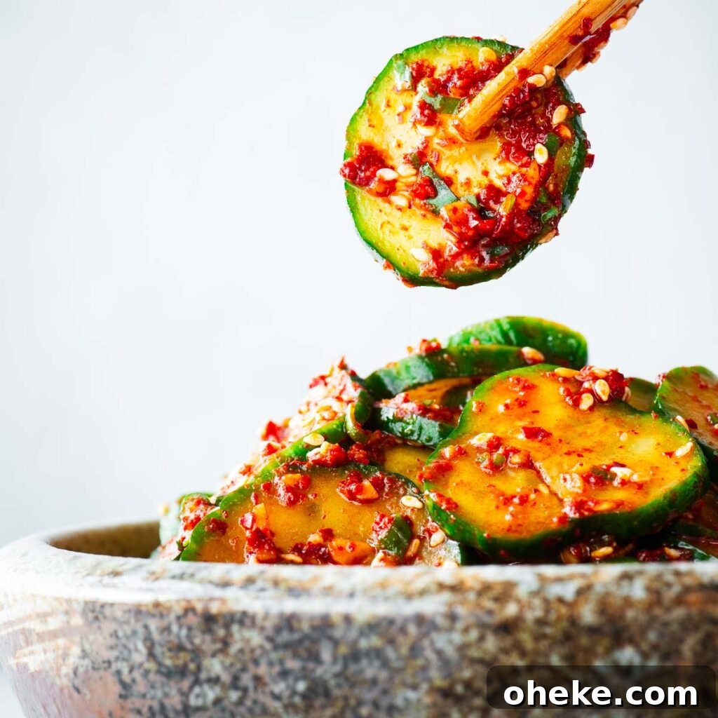 Spicy Gochujang Korean Noodles Recipe 13 A serving of Korean spicy cucumber salad being enjoyed with chopsticks.