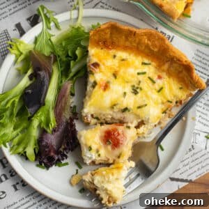 This is a square picture of tomato bacon goat cheese quiche with gruyere.