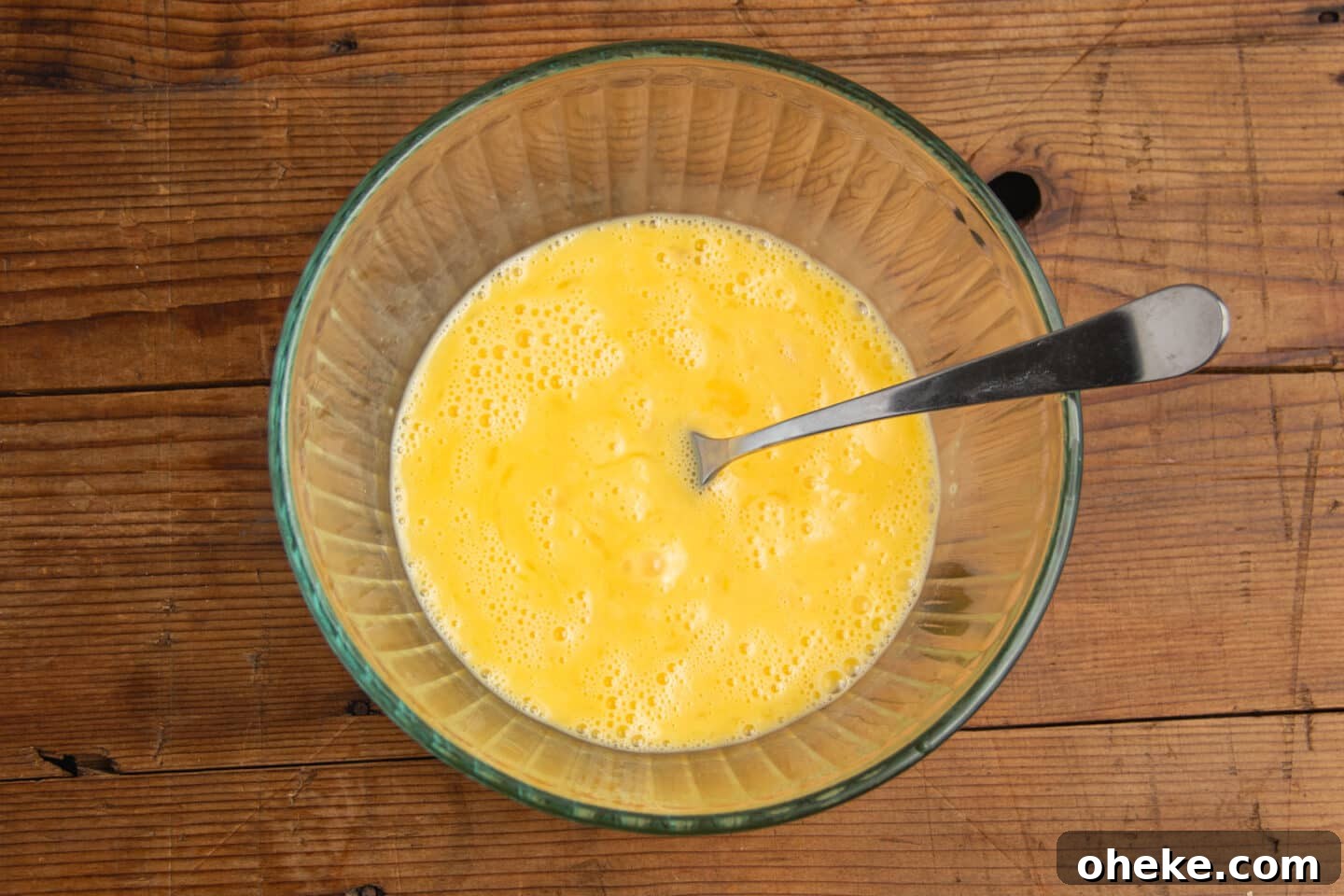 This is picture of the eggs being whisked in a bowl.