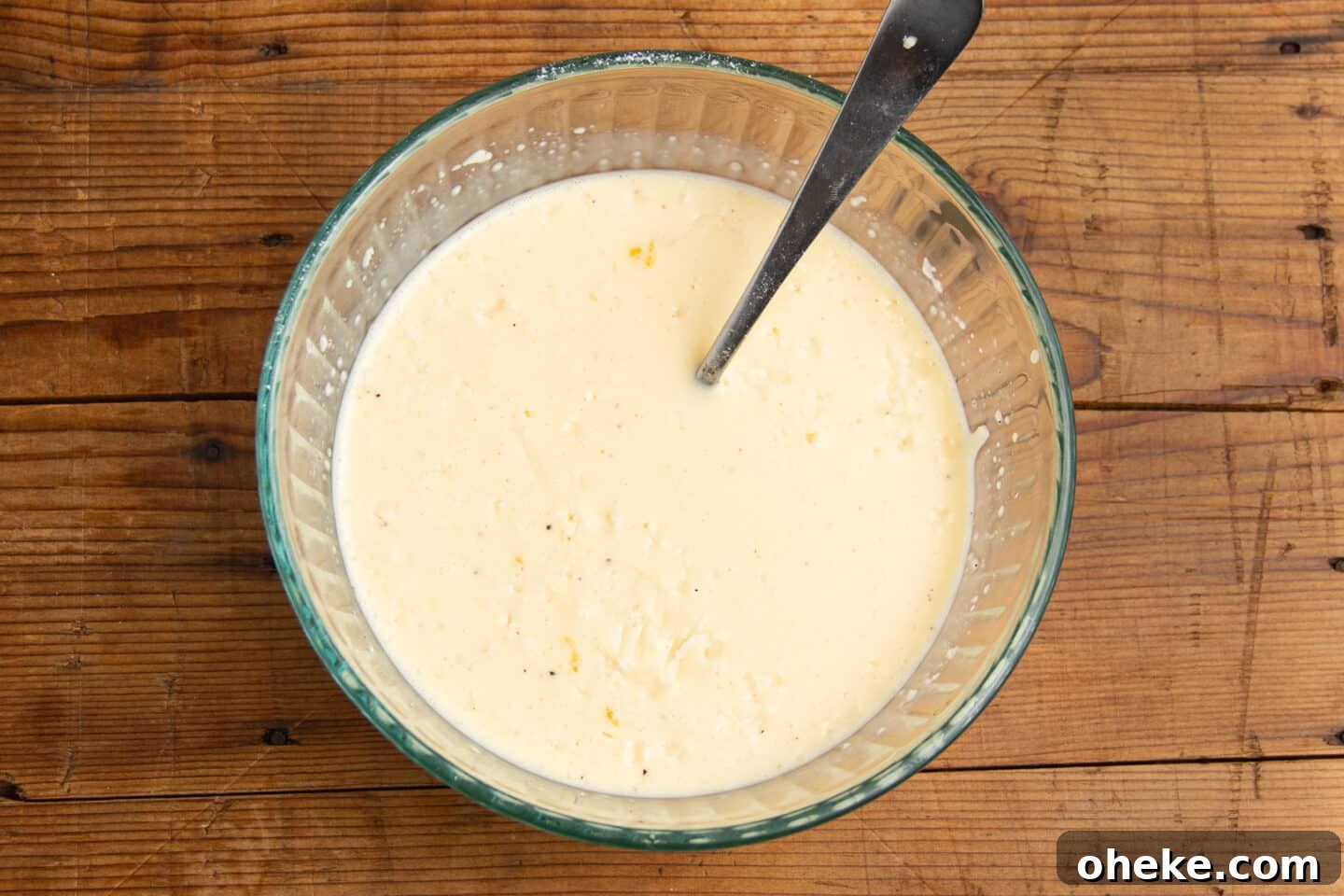 This is picture of the eggs in a bowl with milk and cheese added.