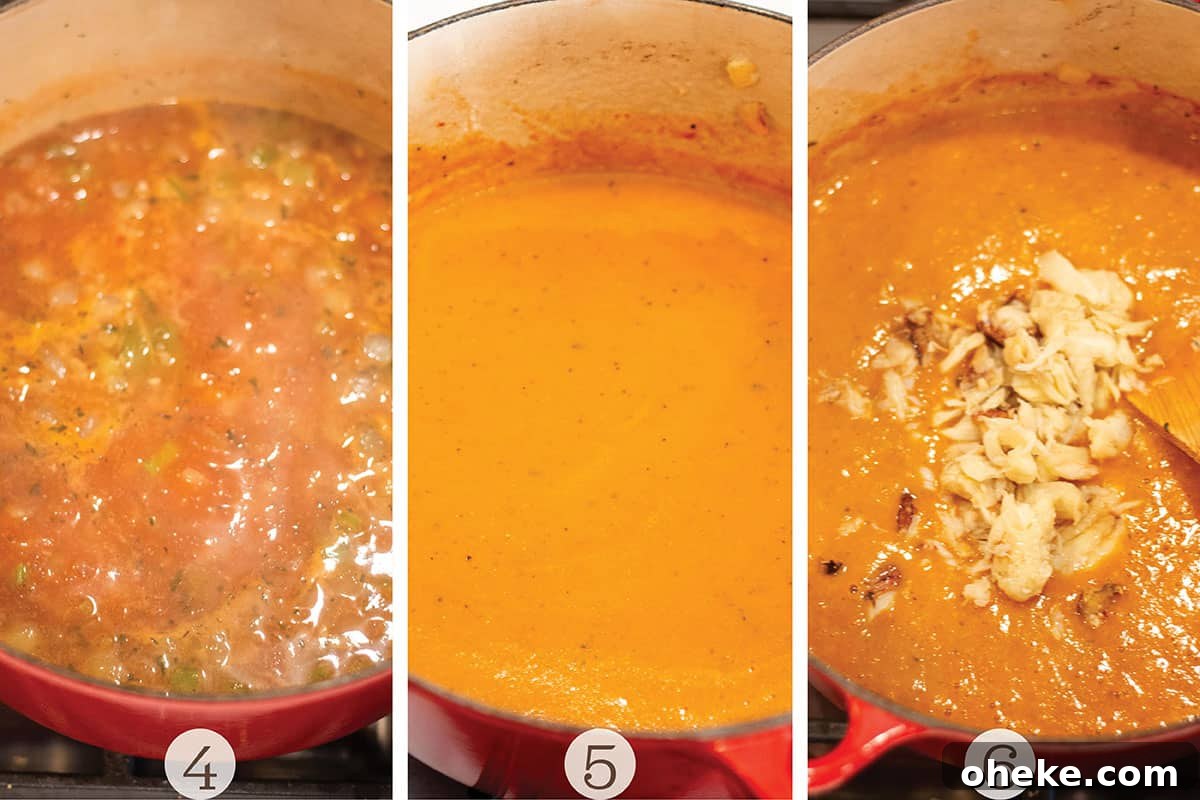 A Dutch Oven with a creamy orange soup with lumps of crab meat.