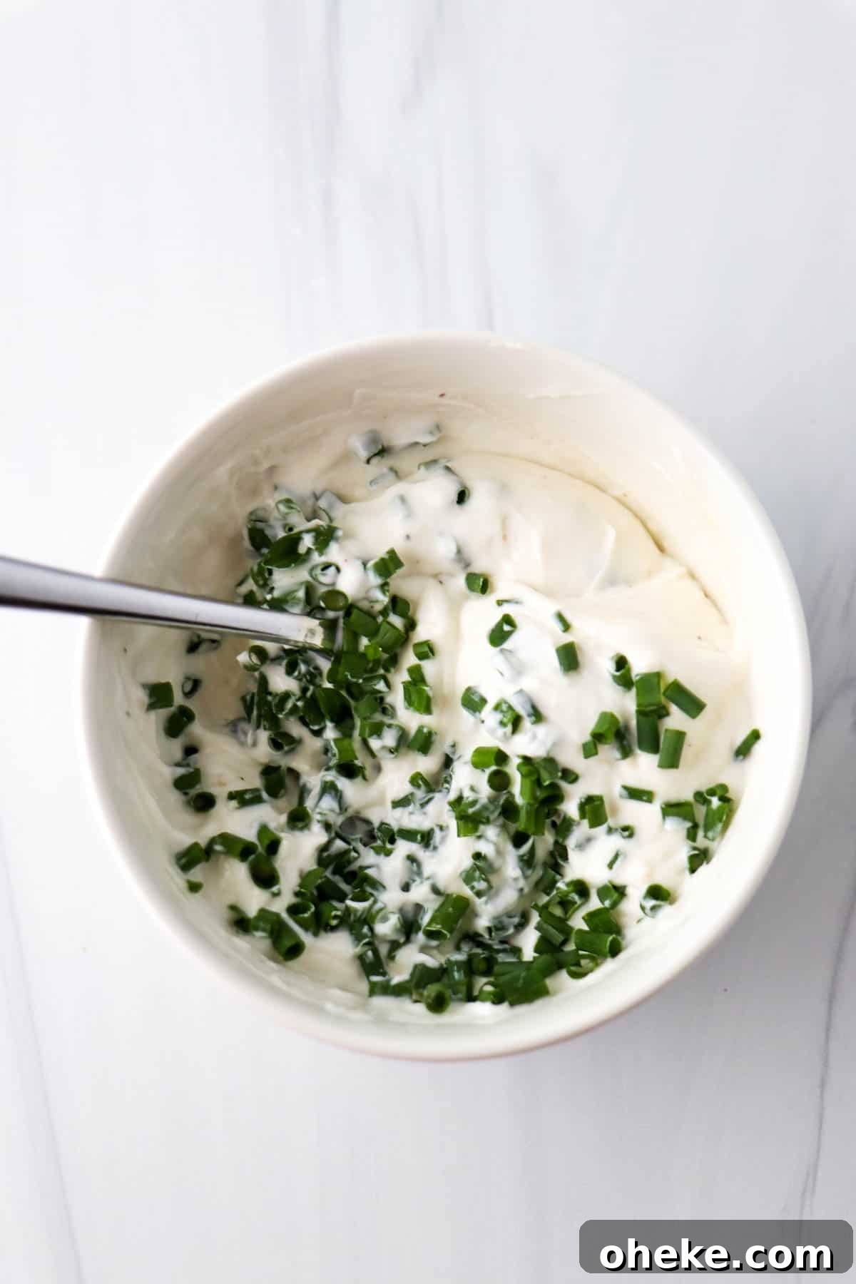 Creamy Horseradish Yogurt Sauce With 3 Simple Ingredients 4 Horseradish Yogurt Sauce in a white bowl topped with chopped fresh chives.