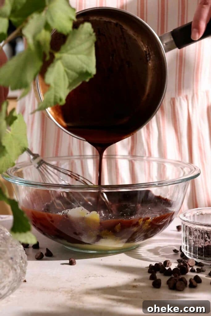 Decadent Chocolate Gooey Cake Recipe for Ultimate Indulgence 5 pouring melted butter and chocolate into batter
