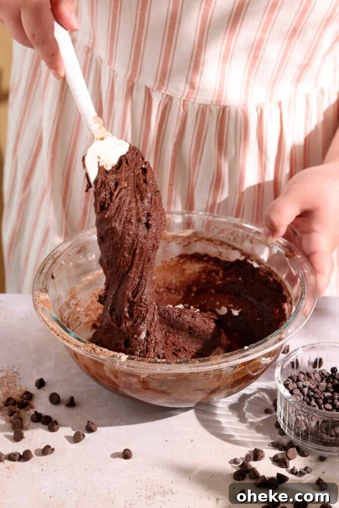 Decadent Chocolate Gooey Cake Recipe for Ultimate Indulgence 6 mixing chocolate cake batter together