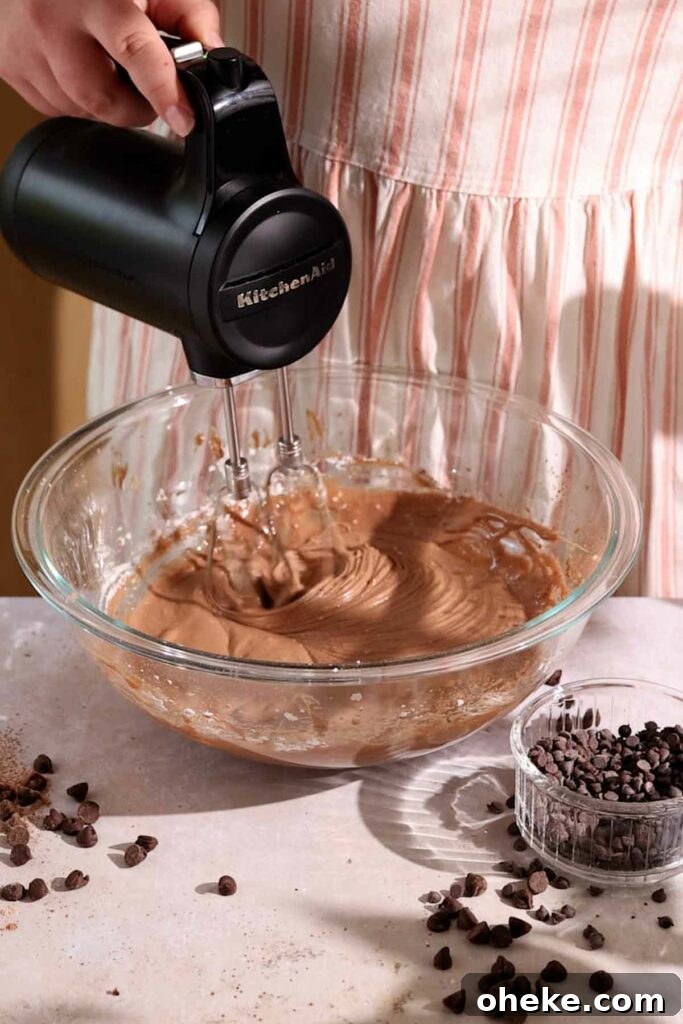 Decadent Chocolate Gooey Cake Recipe for Ultimate Indulgence 8 beating filling together