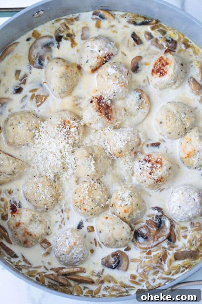 chicken meatballs in a skillet with cream