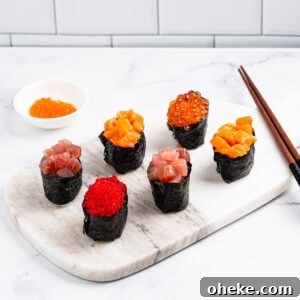 How to Make Gunkan Sushi: Step-by-Step Recipe and Tips 11 6 gunkan on a marble serving board: 1 tobiko gunkan, 2 tuna gunkans, 2 salmon gunkans and 1 ikura gunkan.