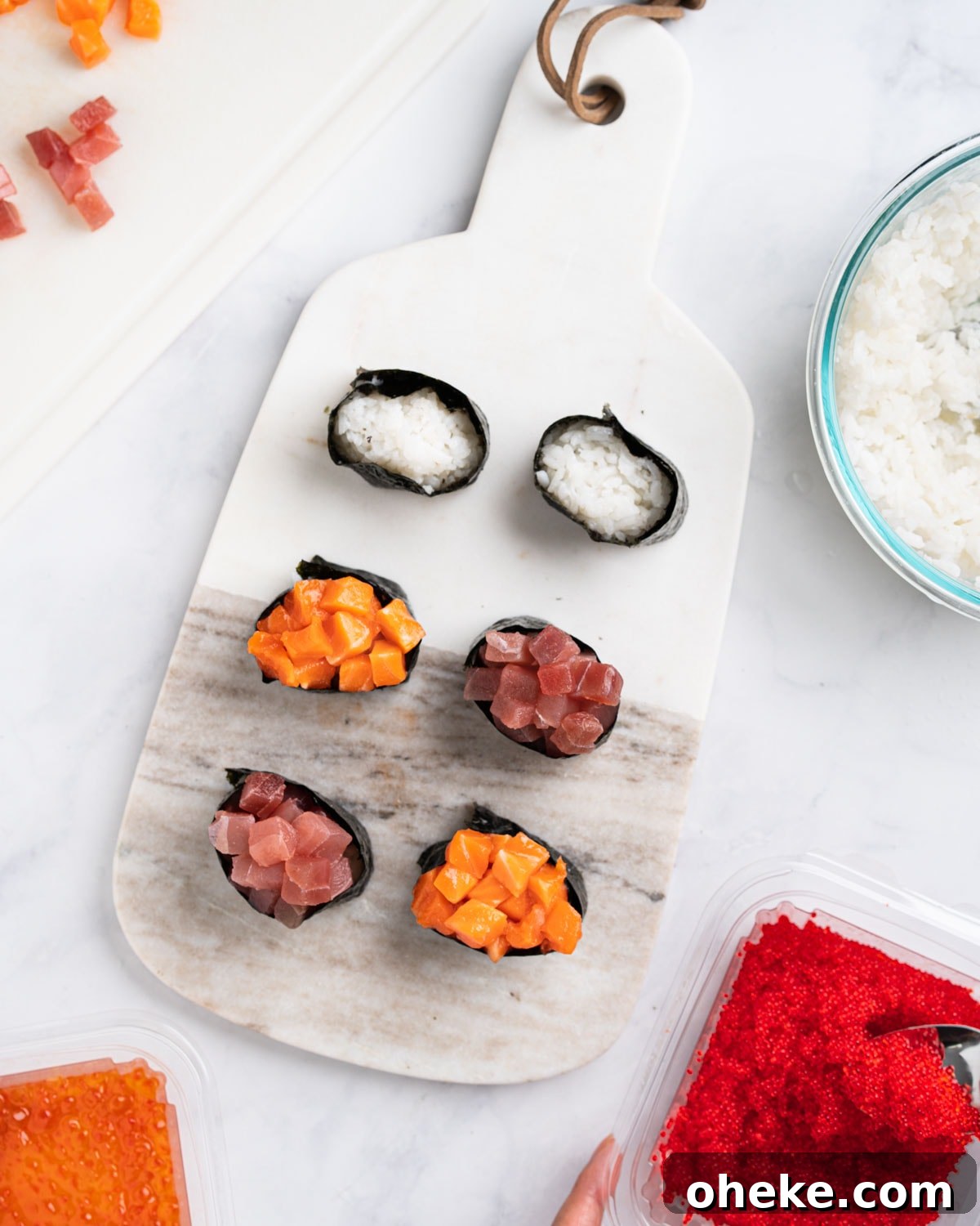 How to Make Gunkan Sushi: Step-by-Step Recipe and Tips 4 Assembling the gunkan with toppings. Rice and toppings surrounding the marble board.