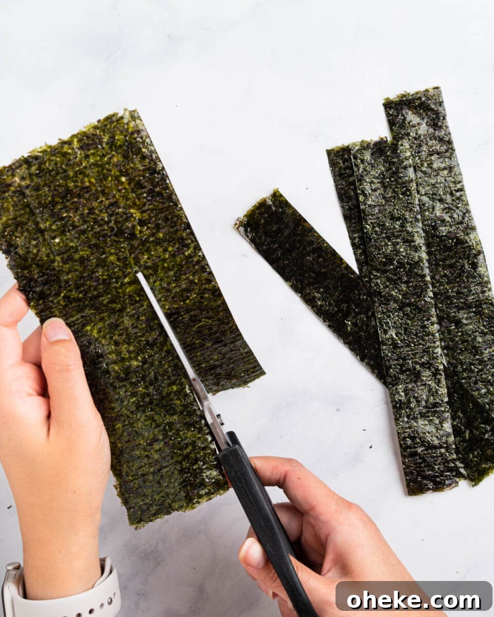 How to Make Gunkan Sushi: Step-by-Step Recipe and Tips 5 Scissors cutting the nori sheet into strips.
