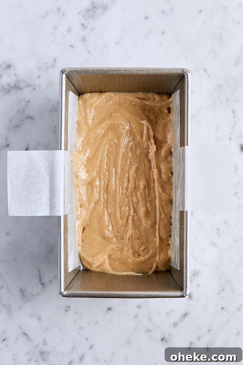 Spiced Apple Fritter Loaf: Cinnamon Apple Bread Recipe 12 Half of the apple bread batter in parchment-lined loaf pan