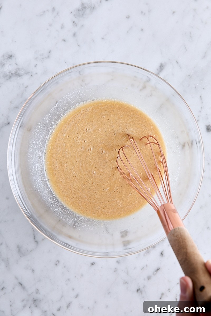 Spiced Apple Fritter Loaf: Cinnamon Apple Bread Recipe 7 Wet ingredients whisked together in glass bowl