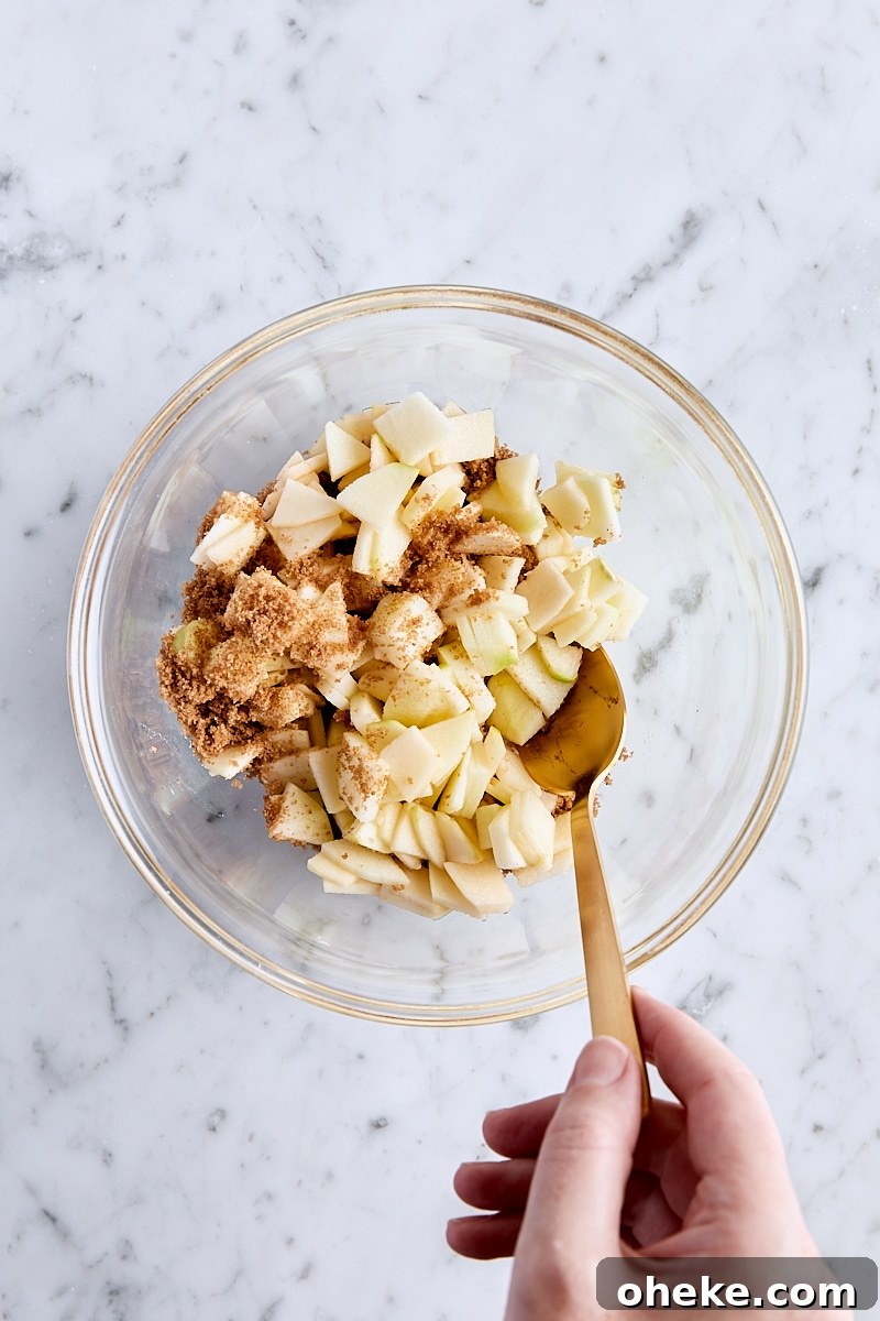 Spiced Apple Fritter Loaf: Cinnamon Apple Bread Recipe 10 Tossing chopped apples with dark brown sugar in a small bowl
