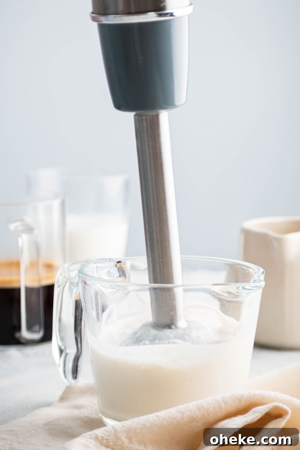 Starbucks Iced White Chocolate Mocha Copycat Recipe — How to Make at Home 5 Electric mixer in a glass pitcher that is filled with cream.