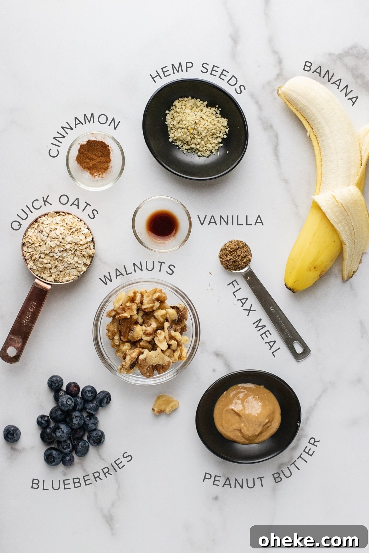 ingredients for an oatmeal bowl arranged on a white counter top.