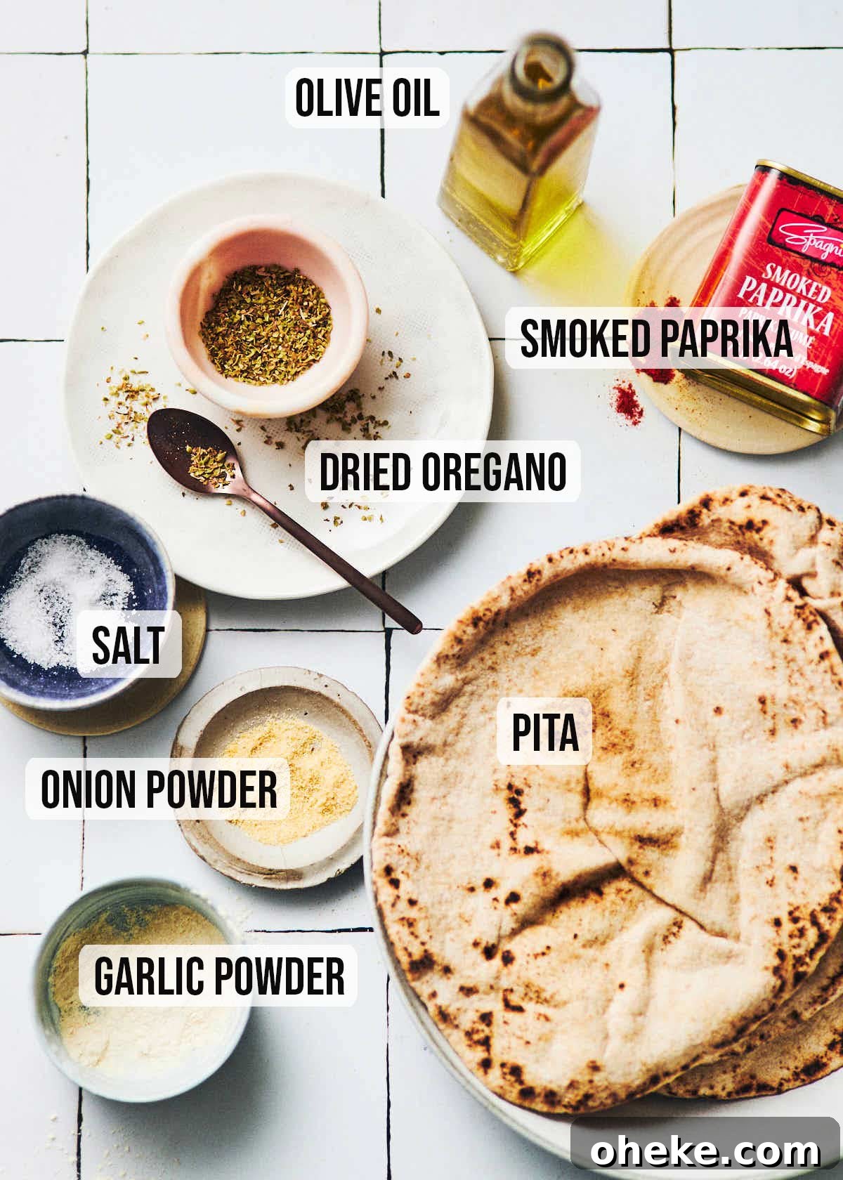Ingredients to make air fryer pita chips: olive oil, smoked paprika, dried oregano, salt, pita, onion powder, garlic powder.