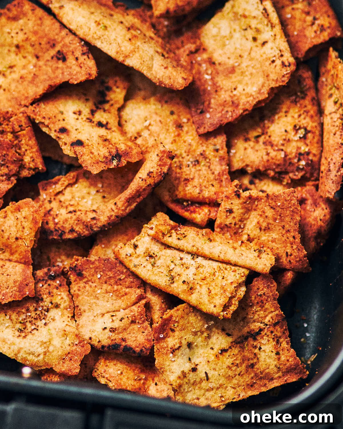 Homemade air fryer pita chips fresh out of an air fryer.