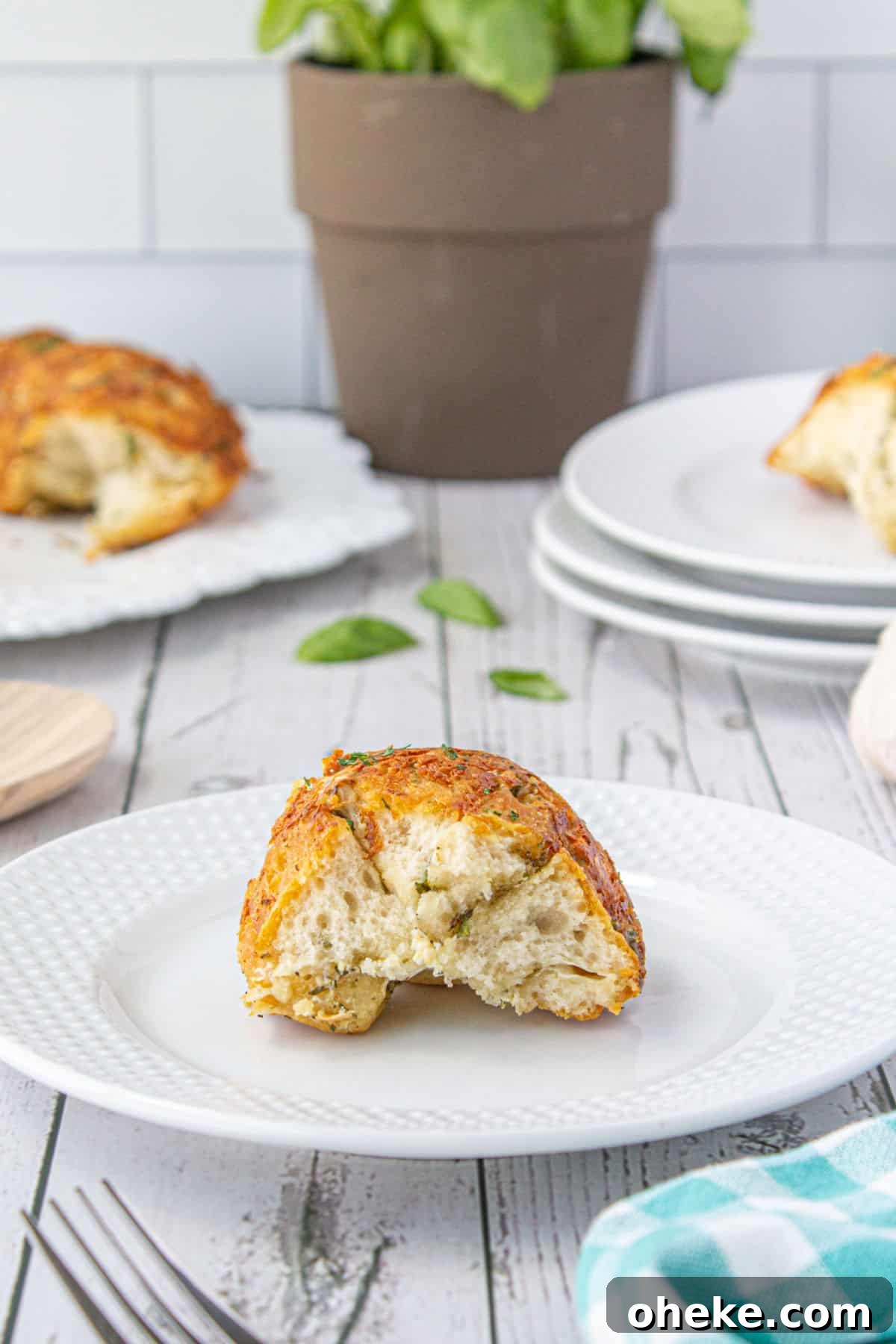 Savory Garlic Pull-Apart Bread Recipe 11 A piece of monkey bread on a plate.