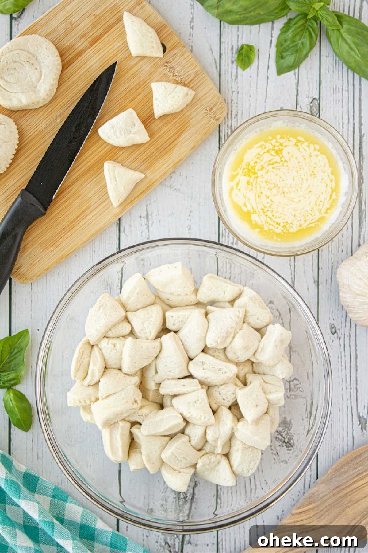 Savory Garlic Pull-Apart Bread Recipe 4 A bowl full of cut refrigerated biscuits.
