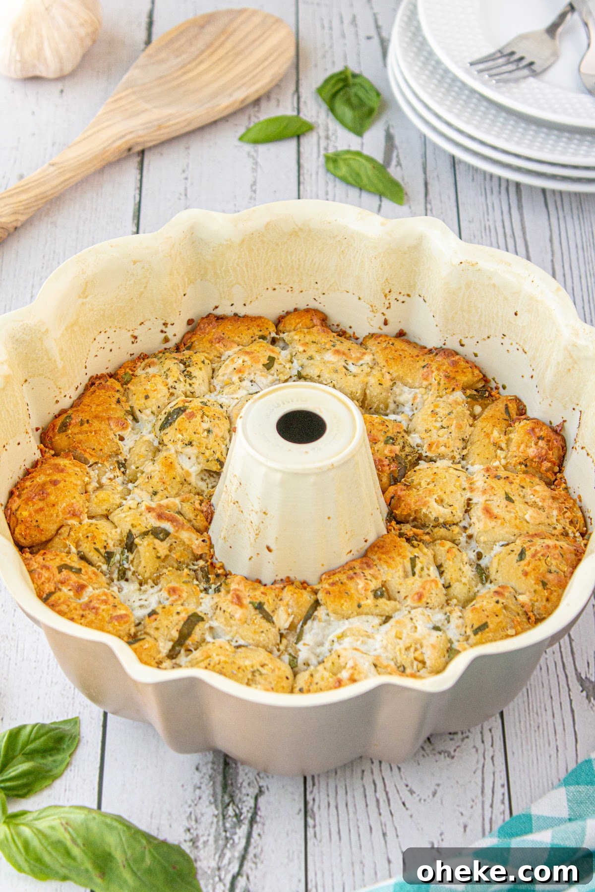 Savory Garlic Pull-Apart Bread Recipe 8 A bundt pan filled with cooked bread and seasonings.