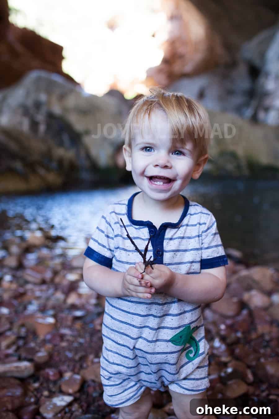 Creating Lasting Memories with Your Toddler: Fun Activities & Tips 7 Making Memories with a young boy in a striped romper standing in front of a cave.
