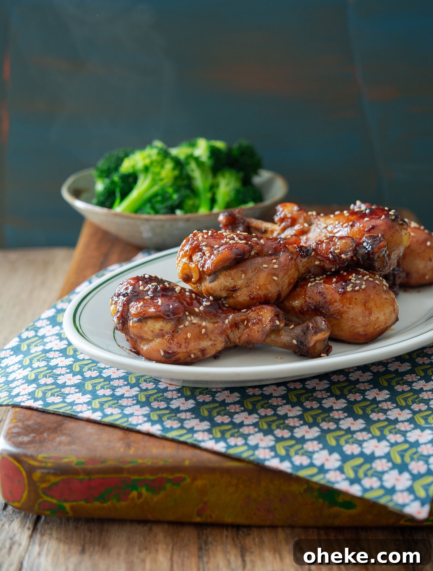 Stovetop teriyaki chicken drumsticks served with steamed broccoli.