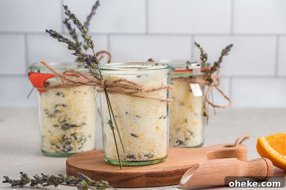 DIY lavender bath salts in jars on a wooden cutting board.