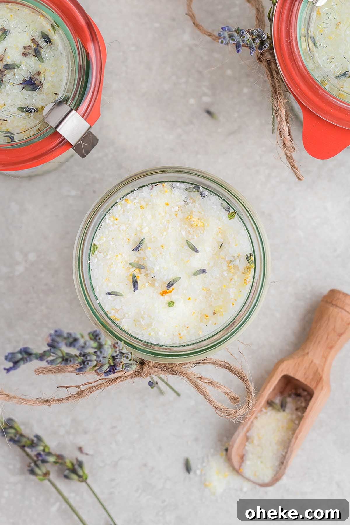 Three jars of lavender sugar with a wooden spoon, perfect for gifting or creating a luxurious bath experience.